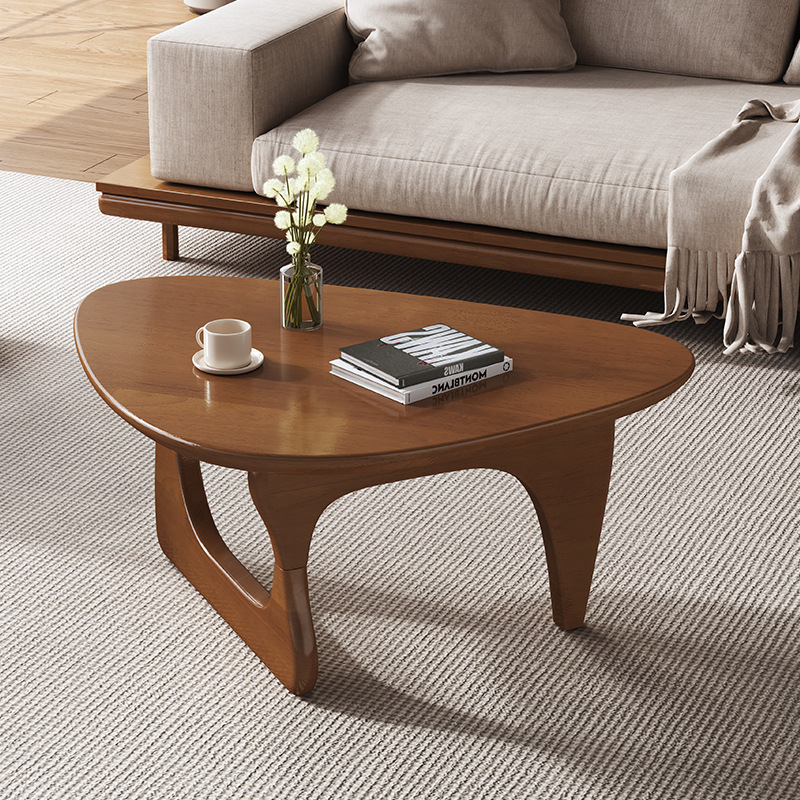 Rounded wooden coffee table shown in the catalog photograph